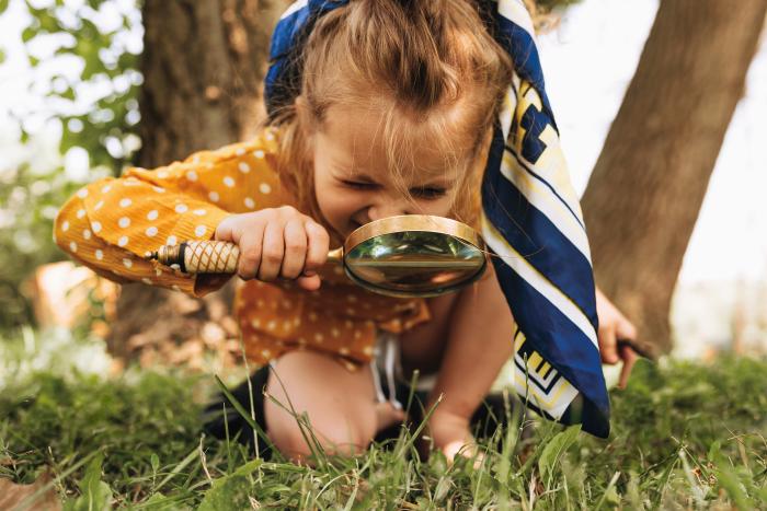 A girl with a magnifying glass