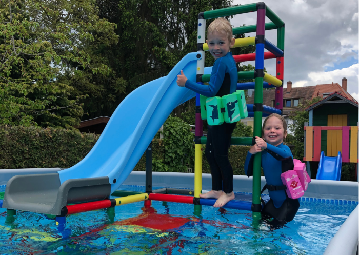 Two children on a water slide